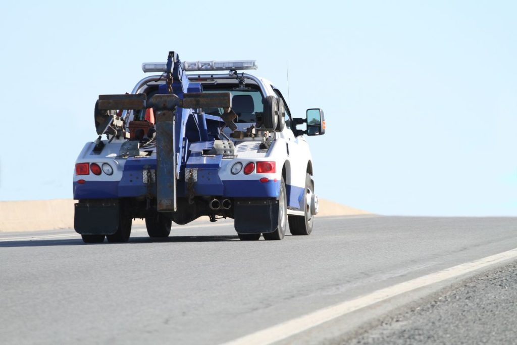 A tow truck by sand dunes